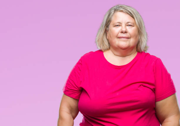 istock Senior plus size caucasian woman over isolated background with serious expression on face. Simple and natural looking at the camera. 1084238546