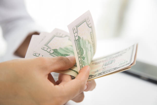 istock money in hand. Business accounting 1084240320