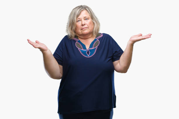 istock Senior plus size caucasian woman over isolated background clueless and confused expression with arms and hands raised. Doubt concept. 1084241422