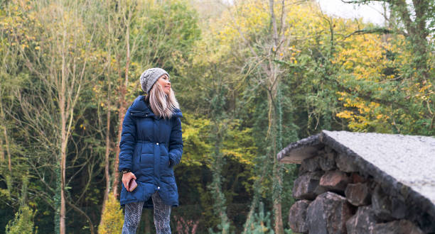 istock Woman chilling in forest at autumn season 1084242592