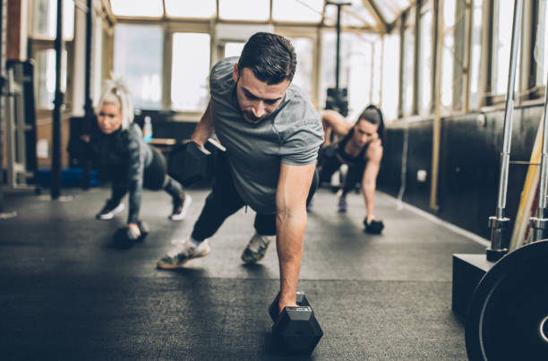 personal weight training in the gym - instructor exercising gym women imagens e fotografias de stock