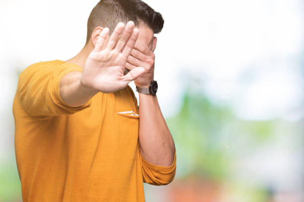 istock Young handsome man over isolated background covering eyes with hands and doing stop gesture with sad and fear expression. Embarrassed and negative concept. 1084252348