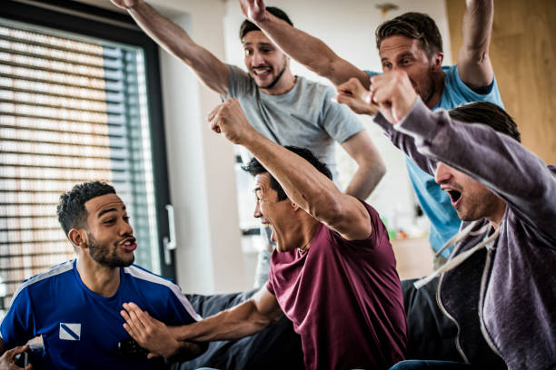 istock Male friends cheering with arms raised 1084253214