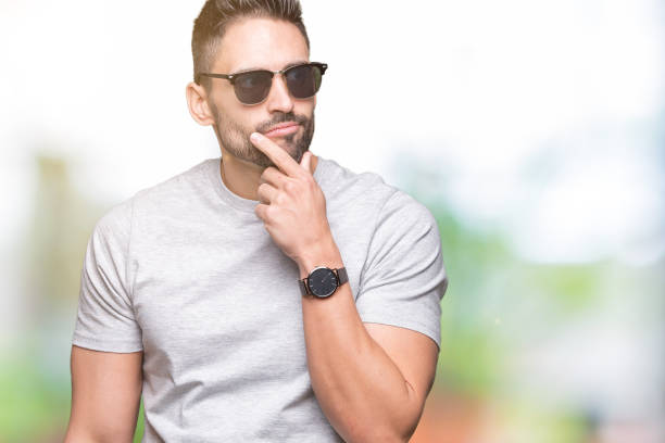 istock Young handsome man wearing sunglasses over isolated background serious face thinking about question, very confused idea 1084253308