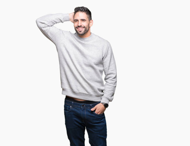 istock Young handsome man wearing sweatshirt over isolated background Smiling confident touching hair with hand up gesture, posing attractive 1084256192