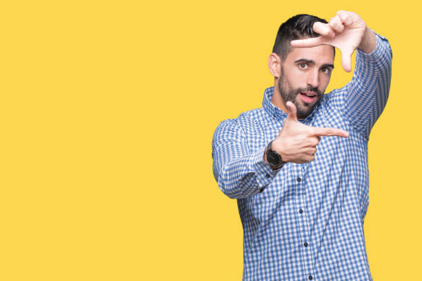 istock Young handsome man over isolated background smiling making frame with hands and fingers with happy face. Creativity and photography concept. 1084256878