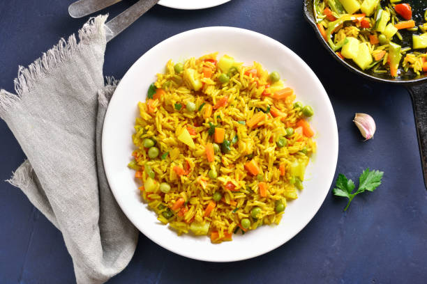 Vegetarian pilaf Pilaf on white plate over blue stone background. Healthy diet food. Top view, flat lay pilau rice stock pictures, royalty-free photos & images