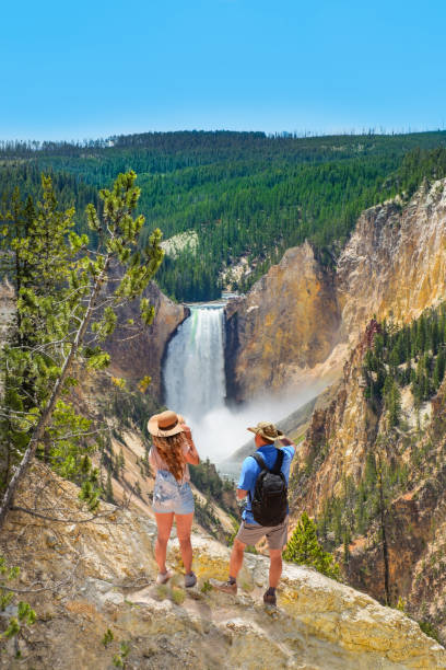 couple relaxing and enjoying beautiful view on vacation hiking trip. - lower falls imagens e fotografias de stock