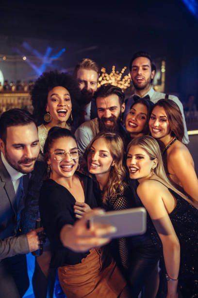 Best friends make the good times better Cheerful friends taking selfie in the nightclub friends in bar with phones stock pictures, royalty-free photos & images