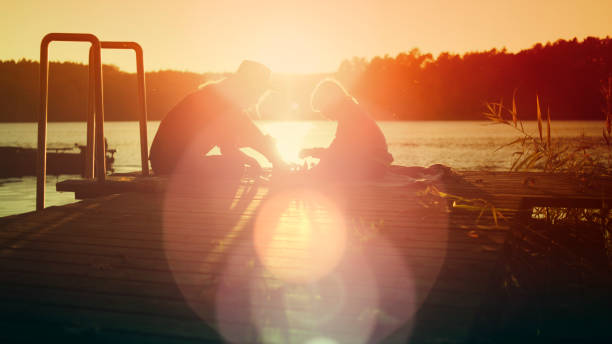 istock Mother and son playing chess on a lake pier 1084271196