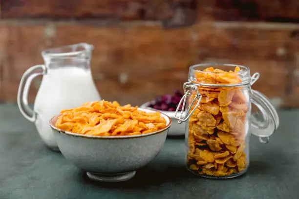 cornflakes cereal and milk in a glass. Morning tasty breakfast concept