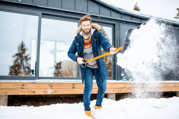 man cleaning snow near the house - snow digging horizontal people imagens e fotografias de stock