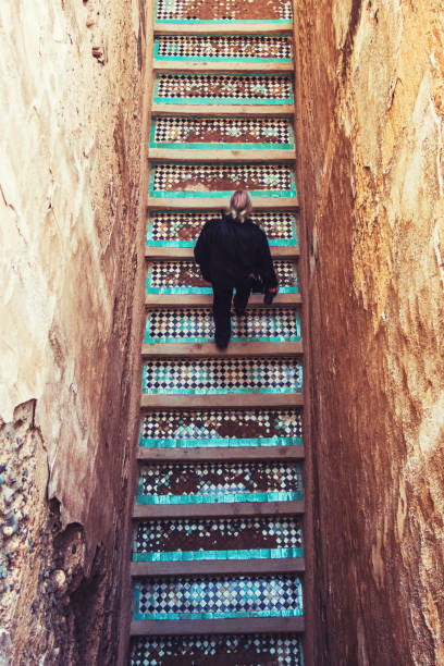 istock Rear View Of Man Moving Up On Steps 1084276976