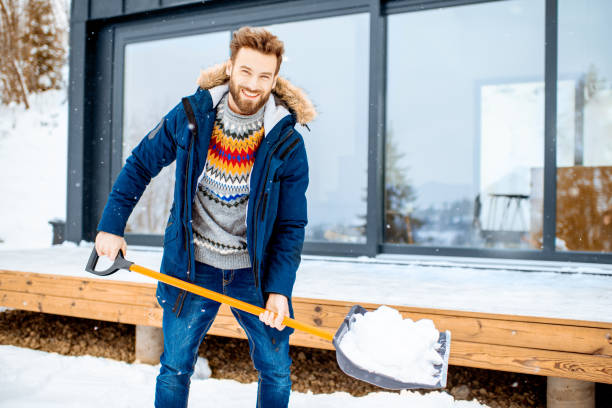 istock Man cleaning snow near the house 1084277010