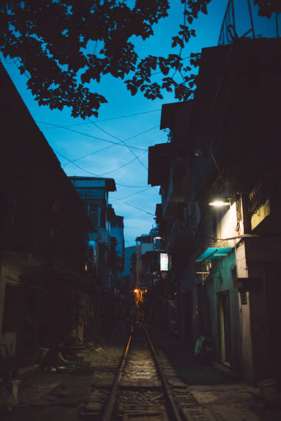 istock Railroad Track Amidst Buildings At Night 1084278370
