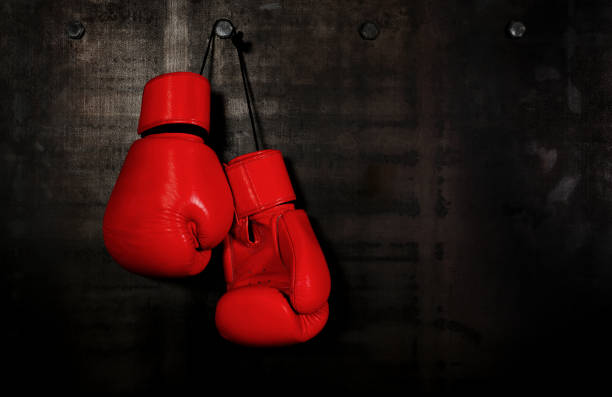 黒い壁に掛かっている赤い革ボクシング グローブ - sports glove protective glove equipment protection ストックフォトと画像