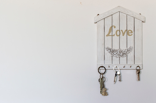 Decorations and objects for interiors. A keychain in the shape of a house as a concept of love and family.