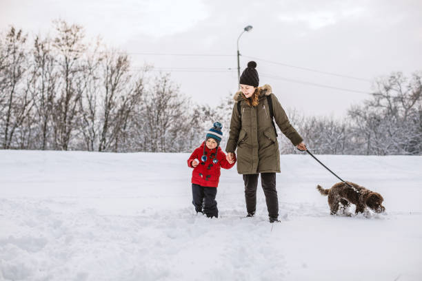 istock Happy young family playing in fresh snow 1084285630