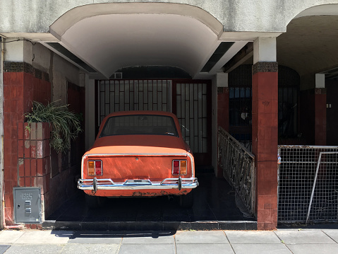 Buenos Aires, Argentina - December 15, 2018: Vintage Fiat sports model parked in home garage. Cars like this one can still be seen moving around the city