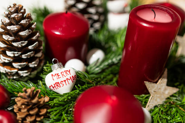 istock Xmas candles on a floral arrangement. 1084289182