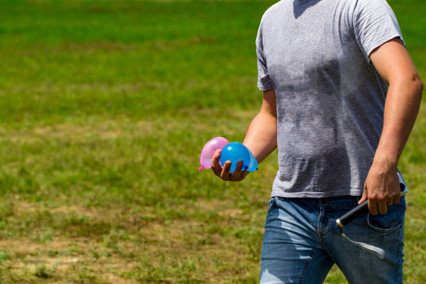 colorful water bombs in summer ready to play. Holding balloons in hand colorful water bombs in summer ready to play. Holding balloons in hand. water balloon stock pictures, royalty-free photos & images