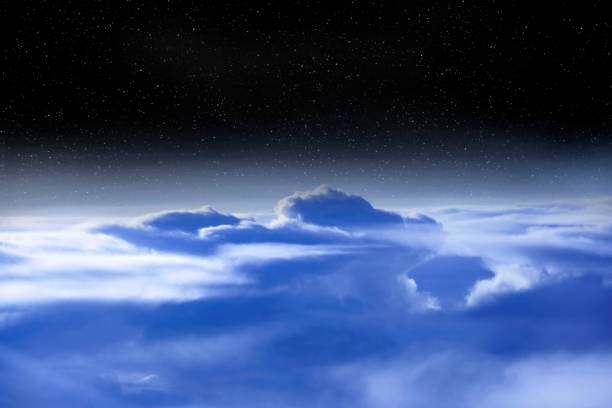 istock Wonderful panorama from window of plane with white clouds 1084289388