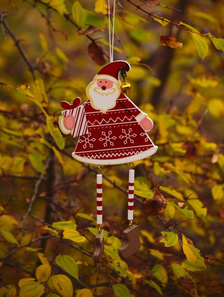 istock Christmas decorative Santa Clause hanging on a tree branch. 1084289662