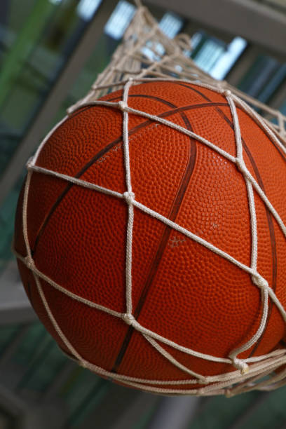 istock One basketball ball hanging in mesh sack 1084289694