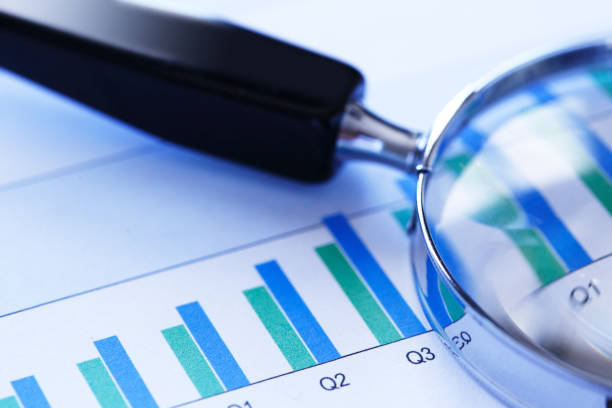 istock Magnifying Glass On Top Of Bar Chart 1084292110