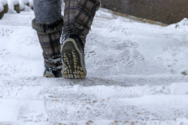 istock A woman goes down a staircase in winter 1084297698