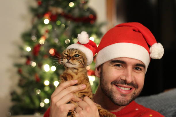 istock Handsome male with his cat during christmas 1084299956