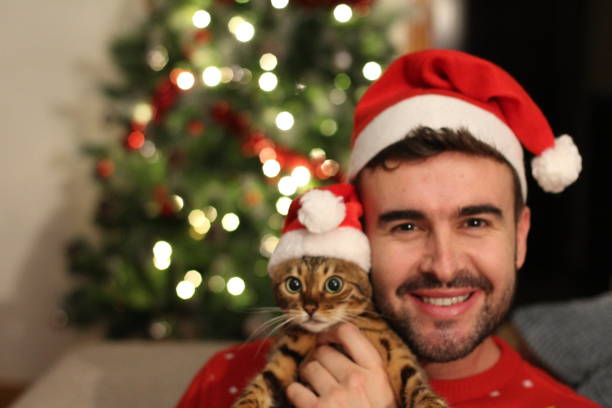 istock Handsome male with his cat during christmas 1084299980