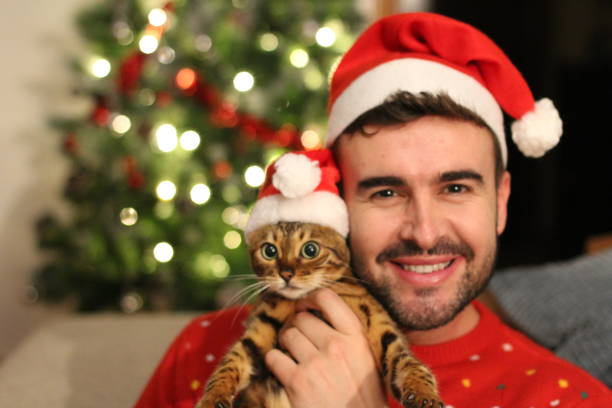 istock Handsome male with his cat during christmas 1084299998