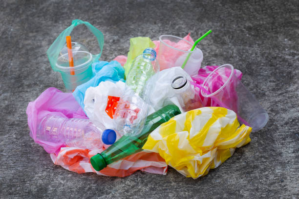 istock Colorful plastic waste, bags, cups, bottles, straws on cement 1084300396