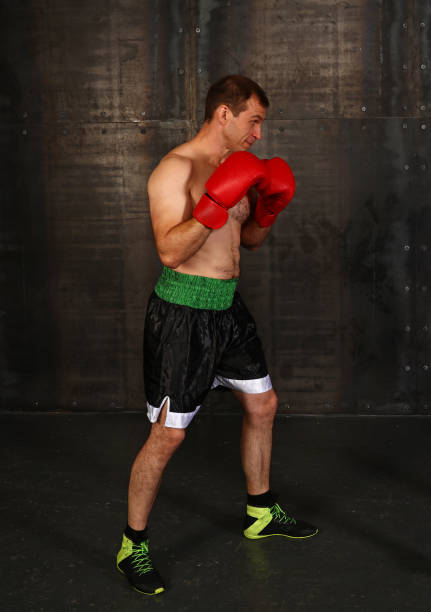 istock Man with red boxing gloves fighting 1084301506