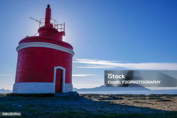Red Lighthouse In Front Of Island Stock Photo - Download Image Now - Atlantic Ocean, Beach, Building Exterior