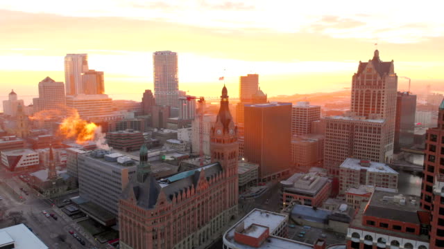 Aerial view of skyscrapers in american city at dawn. Downtown Milwaukee, Wisconsin, United States. Drone shots, sunrise, sunlight, from above.