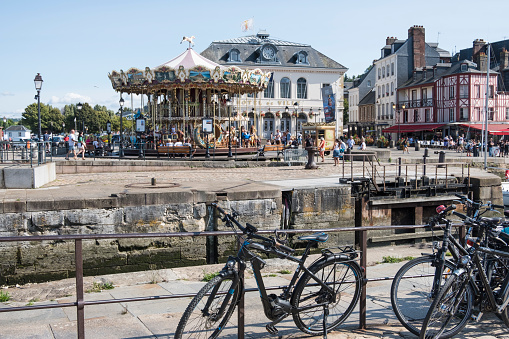 Honfleur, France - August 20, 2018: Town hall and carousel in medieval city Honfleur. Normandy, France