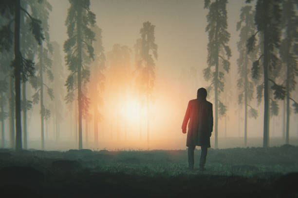 istock Man in the forest at night with landing UFO 1084312584