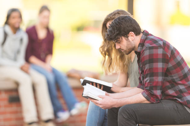 istock College students praying outside on campus 1084316354