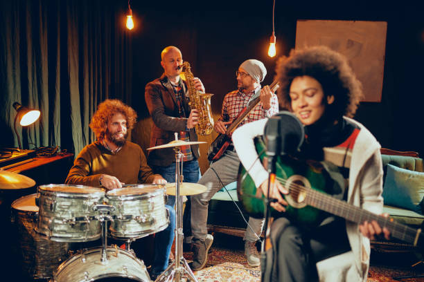 istock Mixed race woman singing and playing guitar. 1084320718