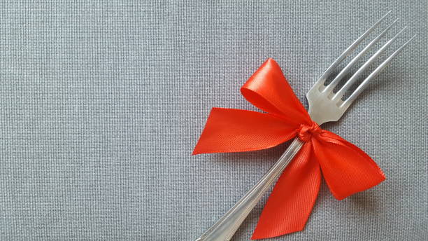 istock A fork with a red bow lies on the tablecloth.  Empty spaces to insert text.  Photo for the menu of cafe, restaurant, dining room, pizzeria. 1084326604