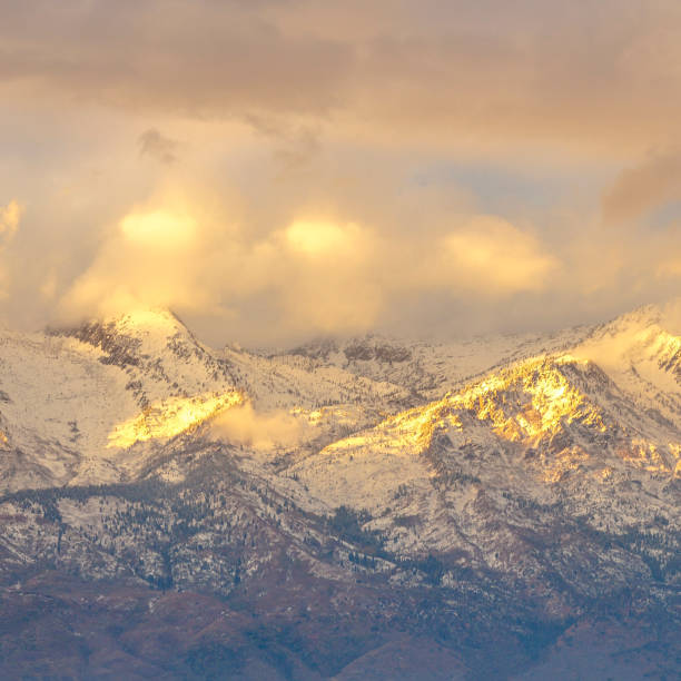 istock Bright sunlight and puffy clouds at Lone Peak Utah 1084329386
