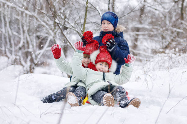 istock Children are playing in winter snowy forest. 1084334532