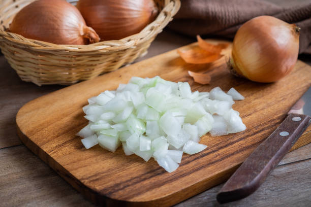 istock Fresh chopped onions on wooden cutting board 1084334634