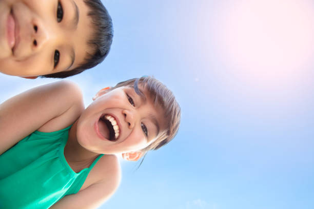 istock closeup happy boy and girl face under sunlight 1084342340