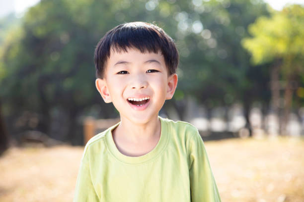 istock closeup asian boy face in the park 1084342378