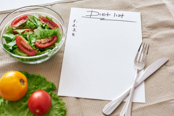 istock Diet list. Fresh vegetables are on the table 1084343826