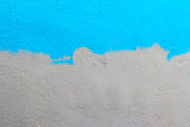 Half Painted Wall - Wallpaper A wall half painted with blue colour. halved stock pictures, royalty-free photos & images