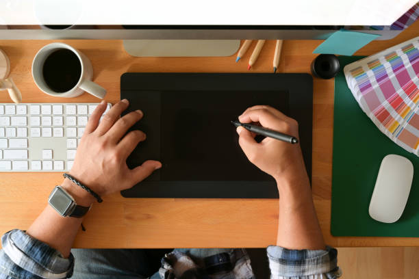 istock Young designer drawing sketches on digital graphic tablet at studio. Top view shot 1084344486